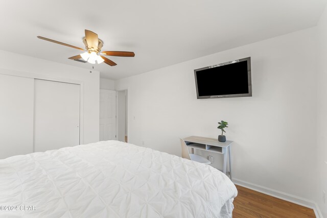 bedroom with a closet, ceiling fan, and wood-type flooring