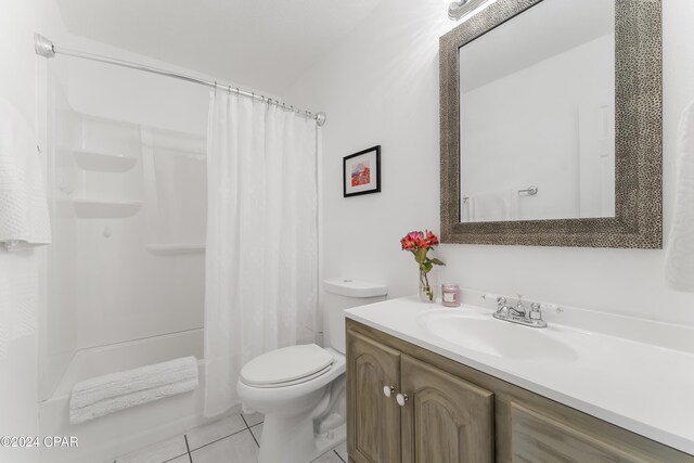 full bathroom featuring toilet, vanity, shower / tub combo with curtain, and tile patterned floors