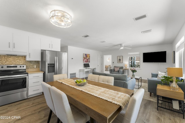 dining room featuring ceiling fan, plenty of natural light, and dark hardwood / wood-style floors