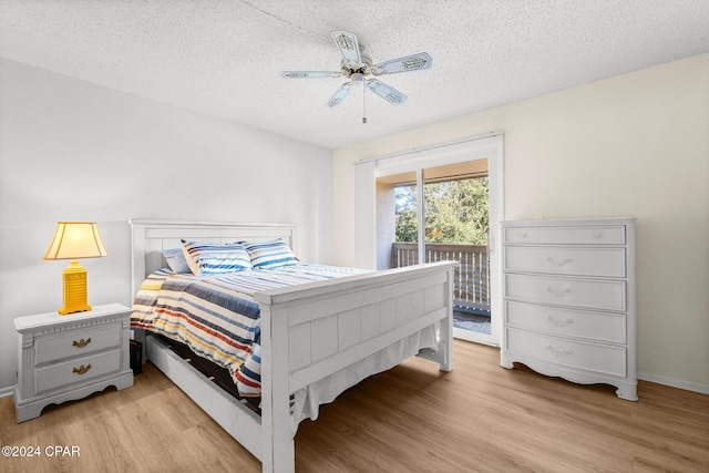 bedroom featuring access to exterior, ceiling fan, light hardwood / wood-style floors, and a textured ceiling