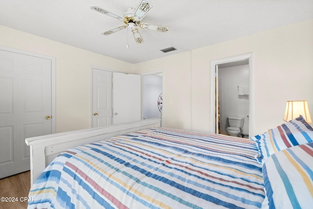 bedroom with connected bathroom, ceiling fan, and hardwood / wood-style flooring