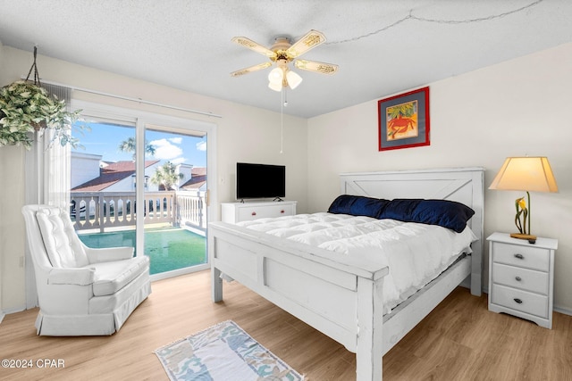 bedroom with access to exterior, ceiling fan, a textured ceiling, and light wood-type flooring