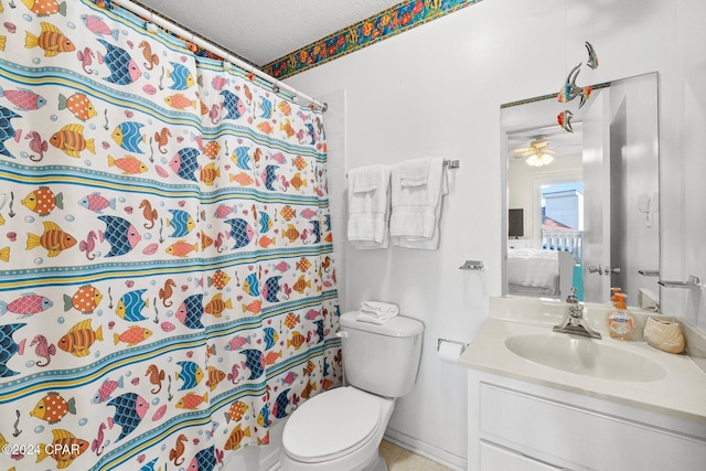 bathroom featuring vanity, a shower with curtain, ceiling fan, toilet, and a textured ceiling