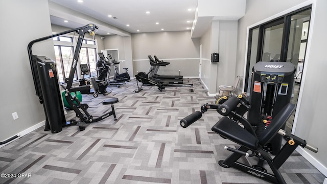 exercise room featuring light colored carpet