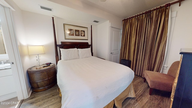 bedroom featuring sink and wood-type flooring