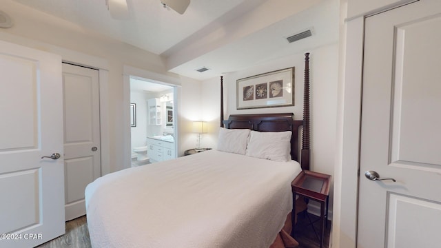 bedroom with hardwood / wood-style floors, ceiling fan, and ensuite bathroom