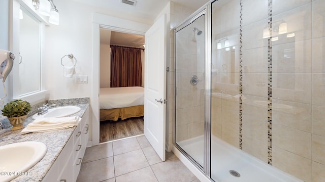 bathroom with tile patterned floors, vanity, and walk in shower