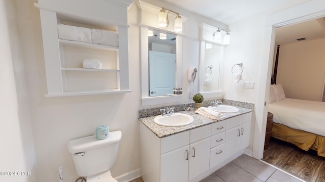 bathroom featuring vanity, hardwood / wood-style flooring, and toilet