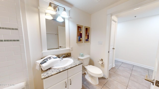 bathroom featuring tile patterned floors, vanity, and toilet