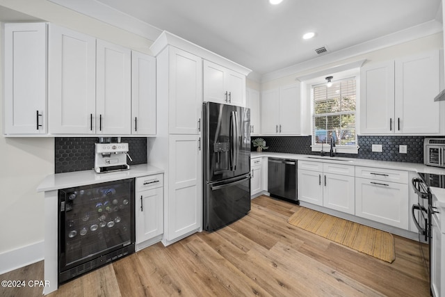 kitchen with white cabinets, black dishwasher, stainless steel refrigerator with ice dispenser, and wine cooler