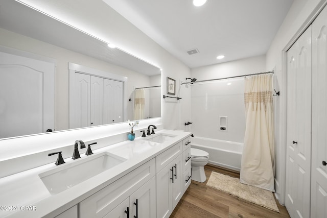 full bathroom with shower / bathtub combination with curtain, vanity, wood-type flooring, and toilet