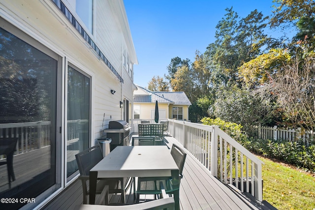 wooden terrace featuring a grill