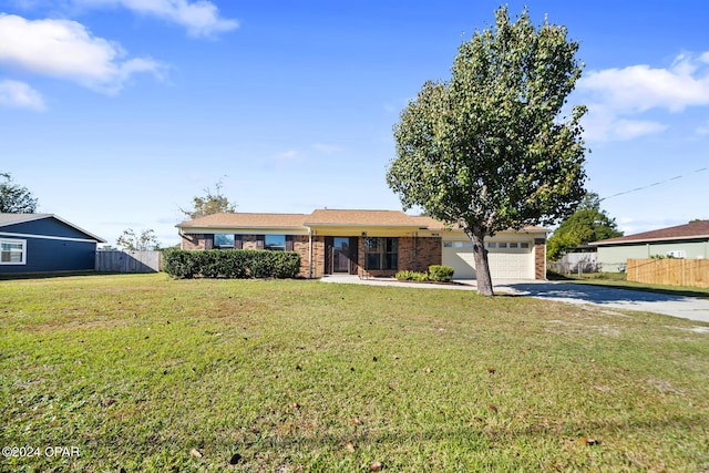 single story home with a garage and a front lawn