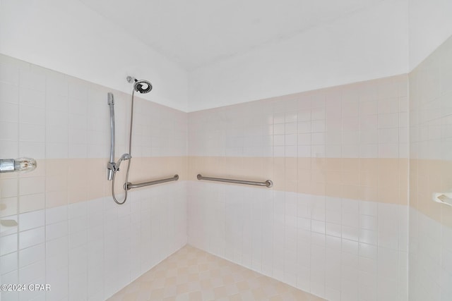 bathroom with tile patterned floors and tiled shower