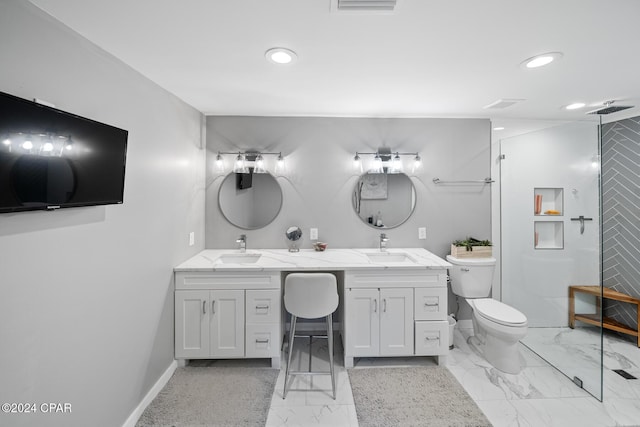 bathroom with double vanity, baseboards, toilet, marble finish floor, and a sink