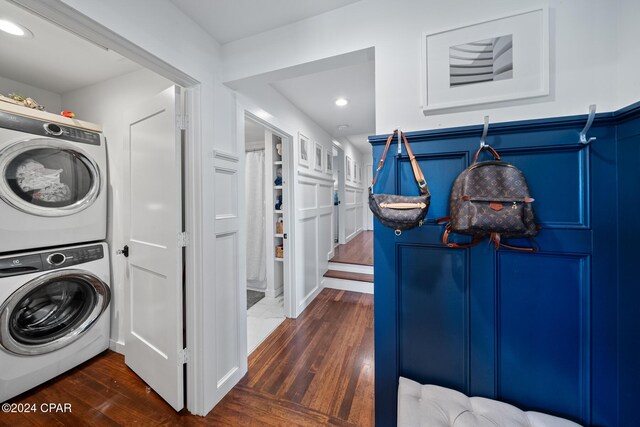 laundry room with laundry area, dark wood finished floors, stacked washer / drying machine, and recessed lighting