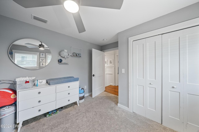 bedroom with visible vents, baseboards, ceiling fan, carpet, and a closet