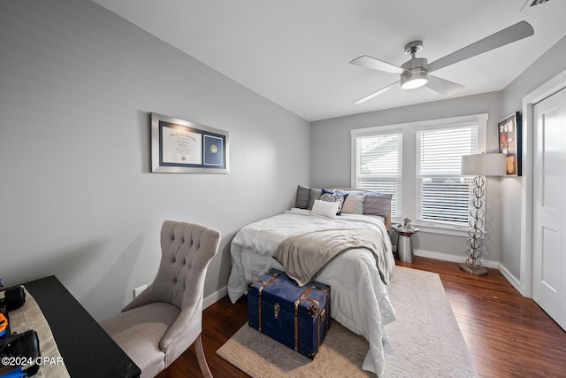 bedroom featuring a ceiling fan, baseboards, and wood finished floors