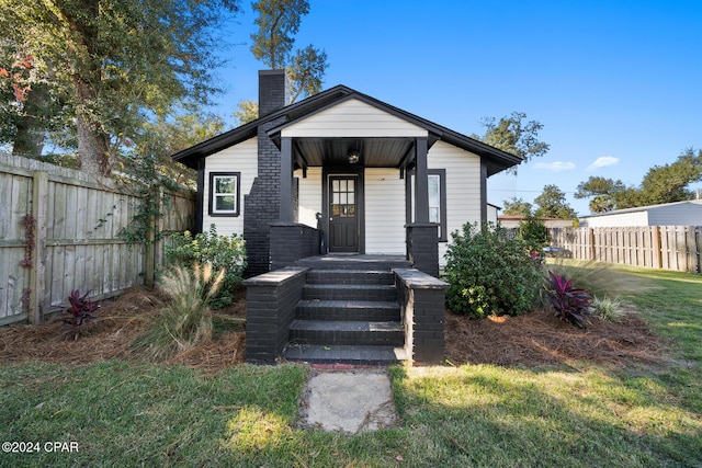 view of front of property with fence and a chimney