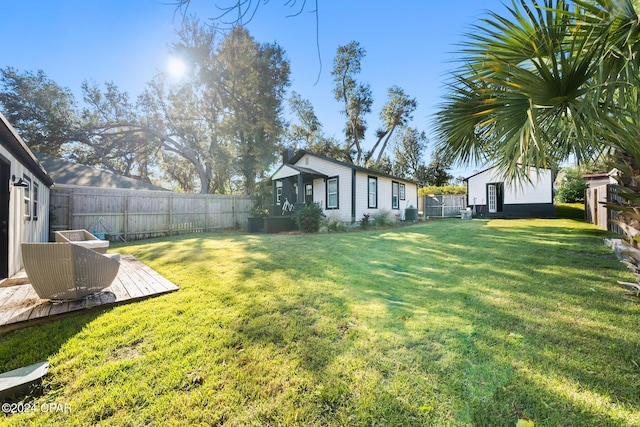 view of yard featuring a fenced backyard and an outdoor structure