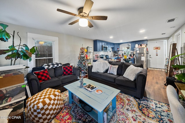 living room with light wood-style floors, visible vents, a ceiling fan, and recessed lighting