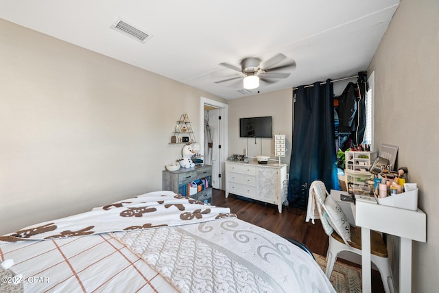 bedroom featuring visible vents, dark wood finished floors, and ceiling fan