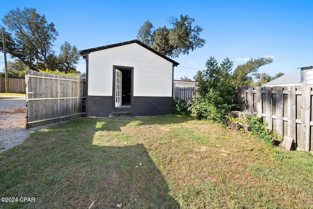 view of yard with an outbuilding and a fenced backyard