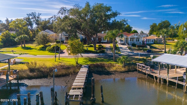 view of dock with a residential view, a water view, and boat lift