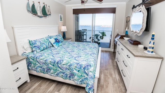 bedroom with ceiling fan, crown molding, light hardwood / wood-style floors, access to outside, and a water view