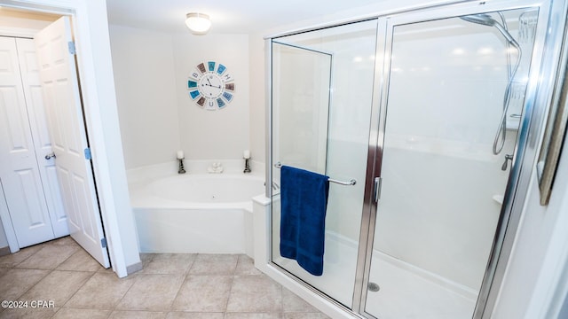 bathroom featuring tile patterned floors and independent shower and bath