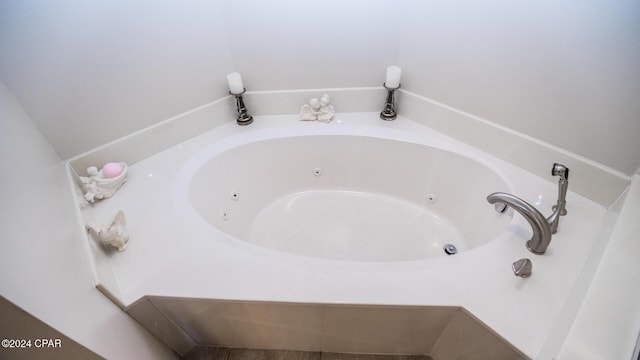 bathroom with a relaxing tiled tub