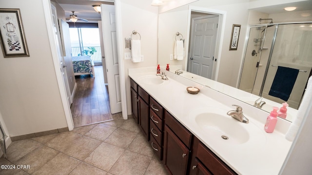 bathroom with ceiling fan, vanity, an enclosed shower, and hardwood / wood-style flooring