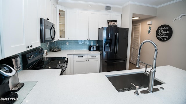 kitchen with black appliances, white cabinets, crown molding, sink, and tasteful backsplash