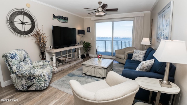 living room featuring ceiling fan, hardwood / wood-style floors, and crown molding