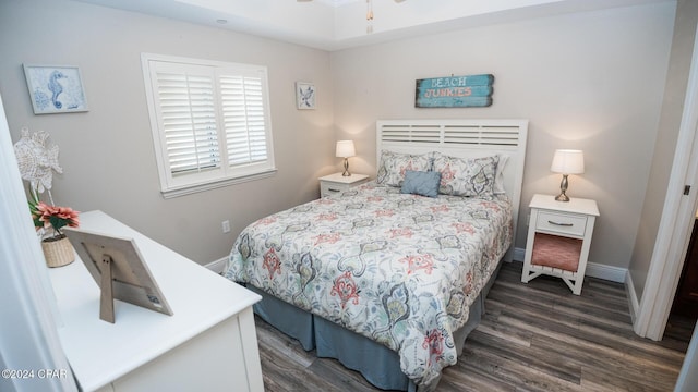 bedroom with dark hardwood / wood-style flooring