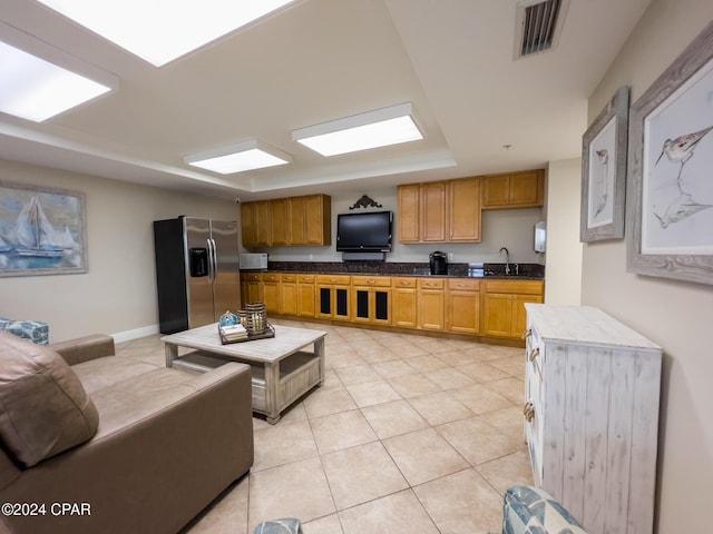 tiled living room featuring sink