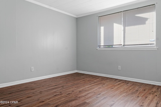 unfurnished room with wood-type flooring and ornamental molding