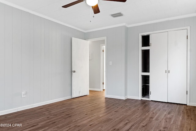 unfurnished bedroom with a closet, hardwood / wood-style flooring, ceiling fan, and ornamental molding