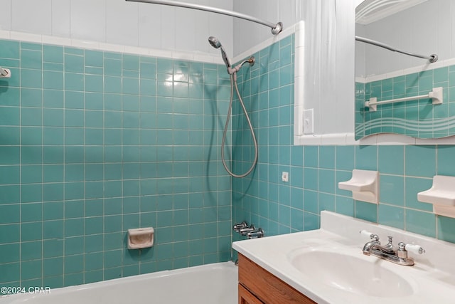 bathroom featuring vanity and tiled shower / bath