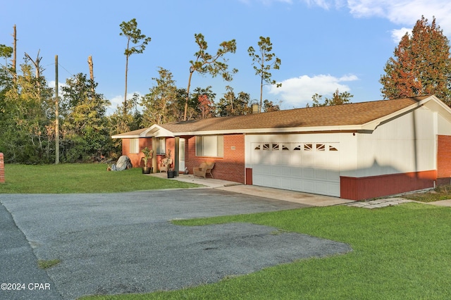 ranch-style home with a front lawn and a garage