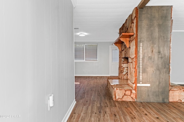 hallway with hardwood / wood-style flooring and ornamental molding