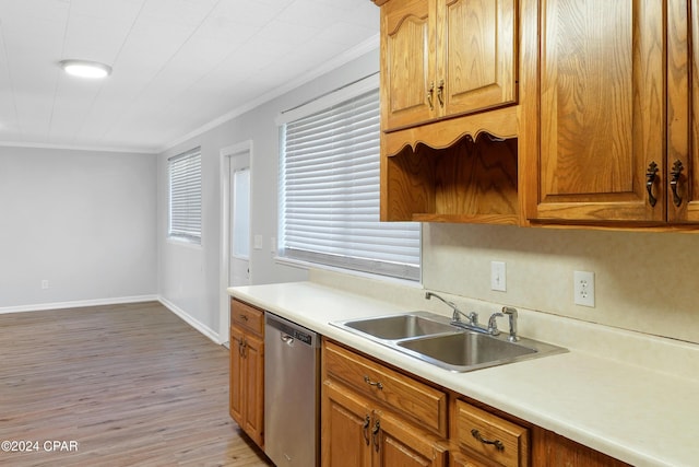 kitchen featuring dishwasher, light wood-type flooring, ornamental molding, and sink