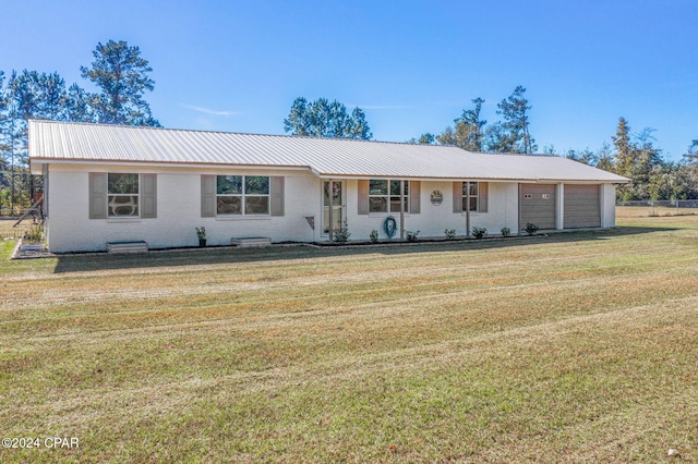 ranch-style house with a garage and a front lawn