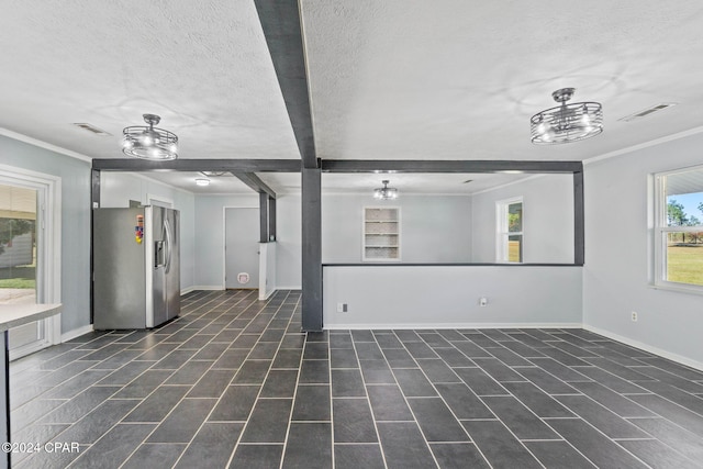 unfurnished living room with beam ceiling, a textured ceiling, and ornamental molding