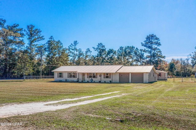 ranch-style home featuring a garage and a front lawn