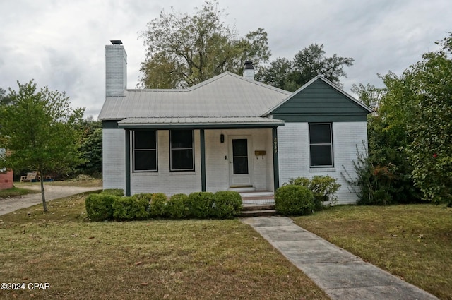 view of front of home with a porch and a front yard