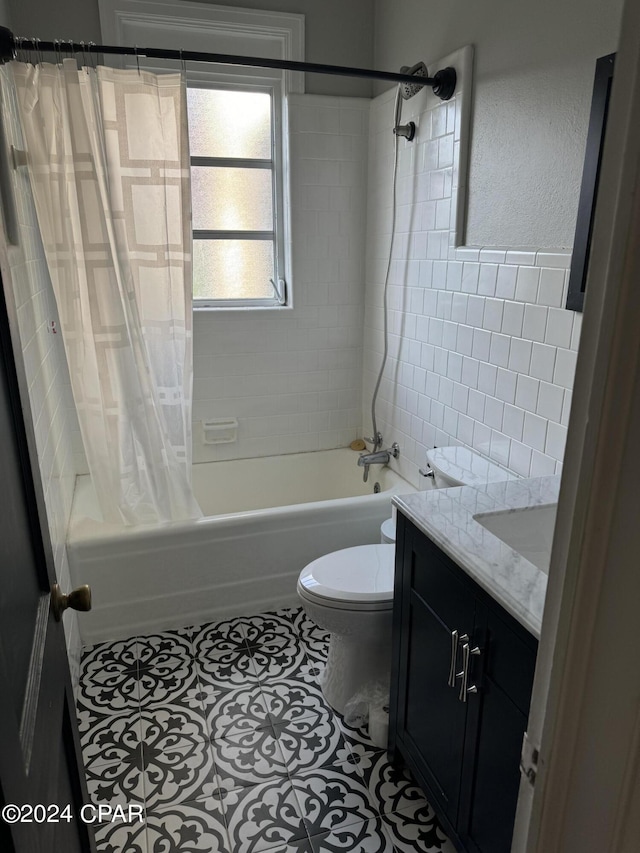 full bathroom featuring tile patterned floors, vanity, shower / bath combination with curtain, and toilet