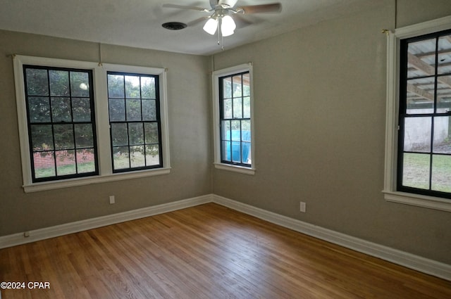 empty room with ceiling fan and wood-type flooring