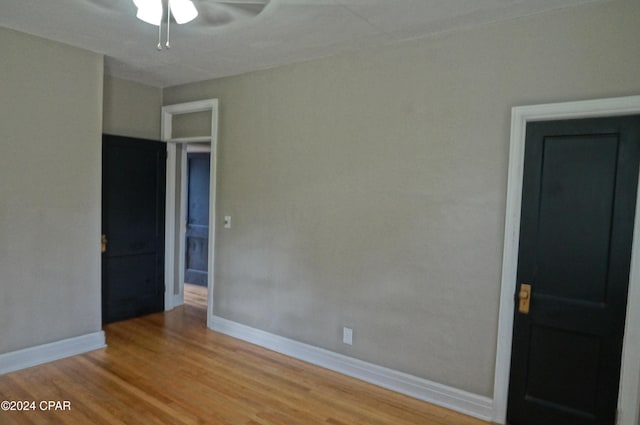 spare room with ceiling fan and wood-type flooring