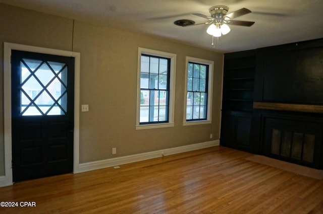 foyer entrance with hardwood / wood-style floors and ceiling fan